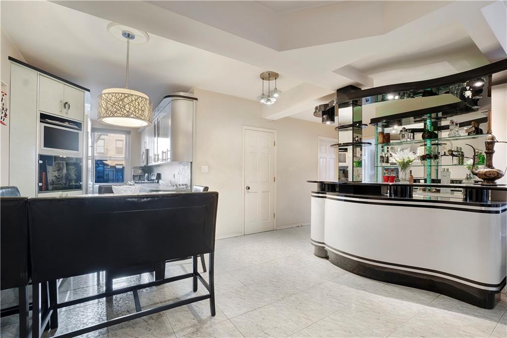 1900 Quentin Road, Unit C4 Brooklyn, NY 11229 - Photo 4 of 13 a kitchen with a table and chairs in it