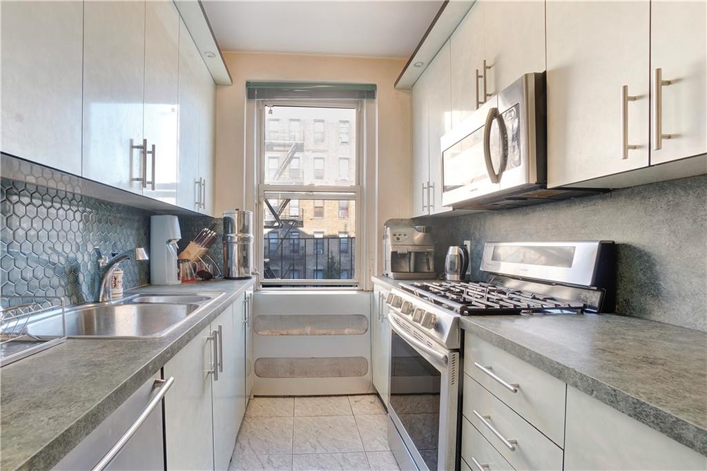 1900 Quentin Road, Unit C4 Brooklyn, NY 11229 - Photo 6 of 13 a kitchen with granite countertop a sink stove and cabinets