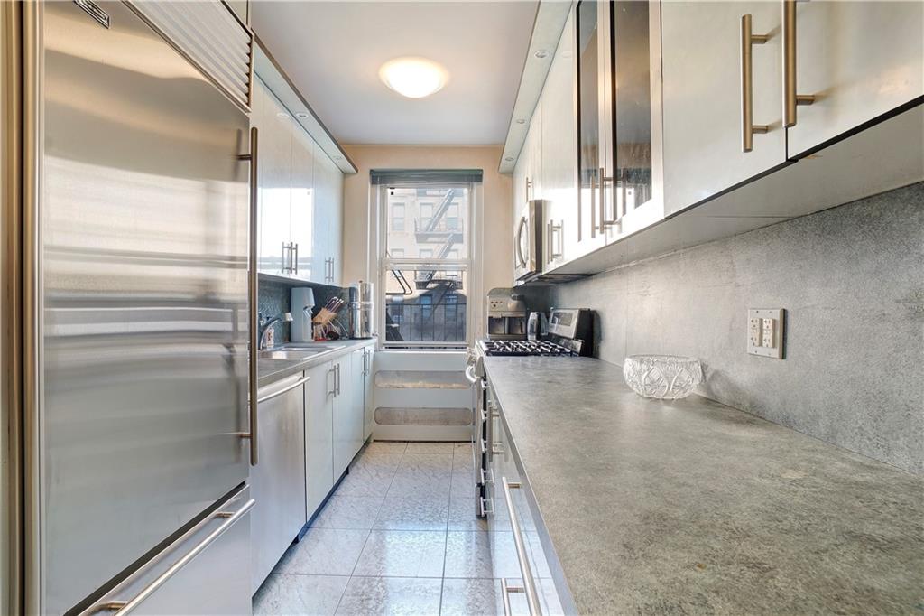 1900 Quentin Road, Unit C4 Brooklyn, NY 11229 - Photo 7 of 13 a kitchen with stainless steel appliances granite countertop a refrigerator and a sink