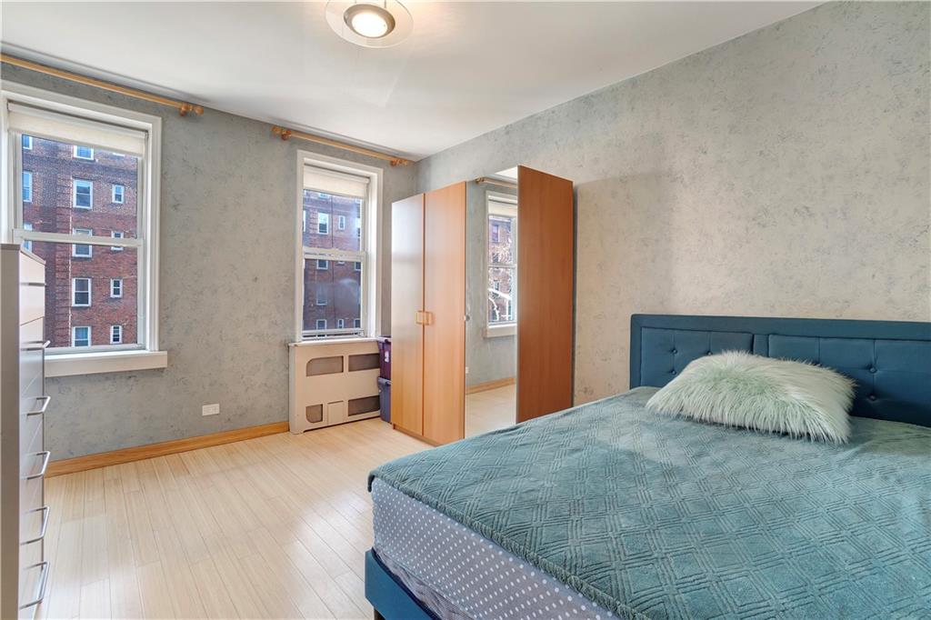 1900 Quentin Road, Unit C4 Brooklyn, NY 11229 - Photo 9 of 13 a bedroom with a large bed and wooden floor
