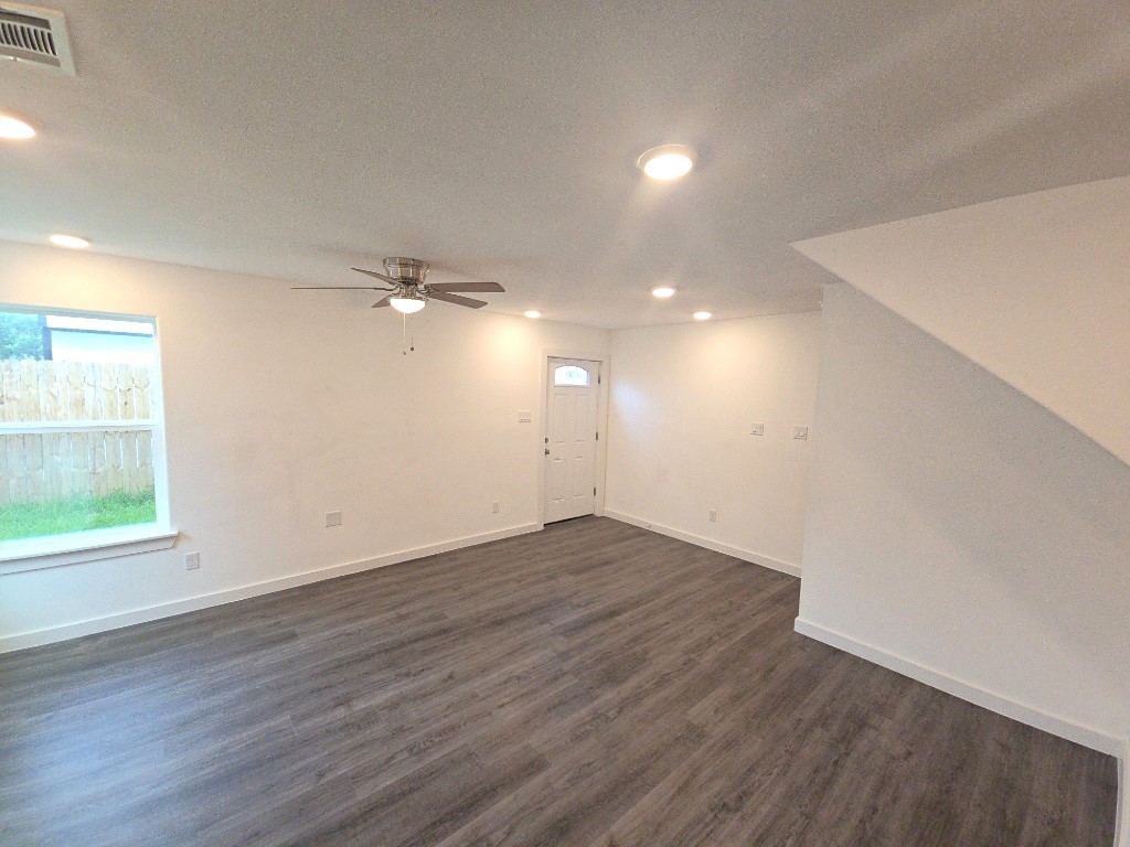 6315 Sandra Street, Unit A Houston, TX 77028 - Photo 5 of 21 an empty room with wooden floor and windows