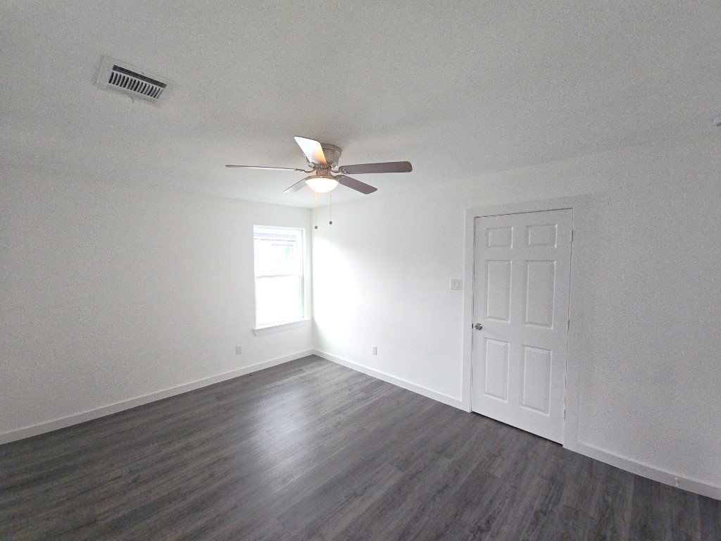6315 Sandra Street, Unit A Houston, TX 77028 - Photo 6 of 21 a view of an empty room with wooden floor and a window