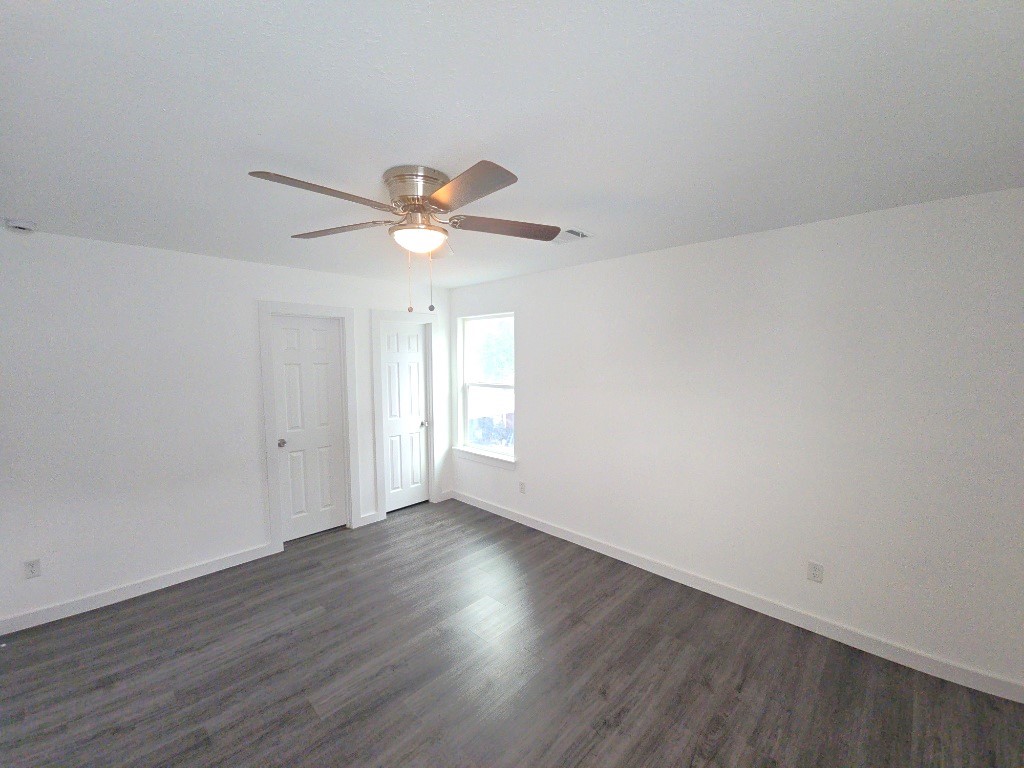 6315 Sandra Street, Unit A Houston, TX 77028 - Photo 7 of 21 an empty room with wooden floor and ceiling fan