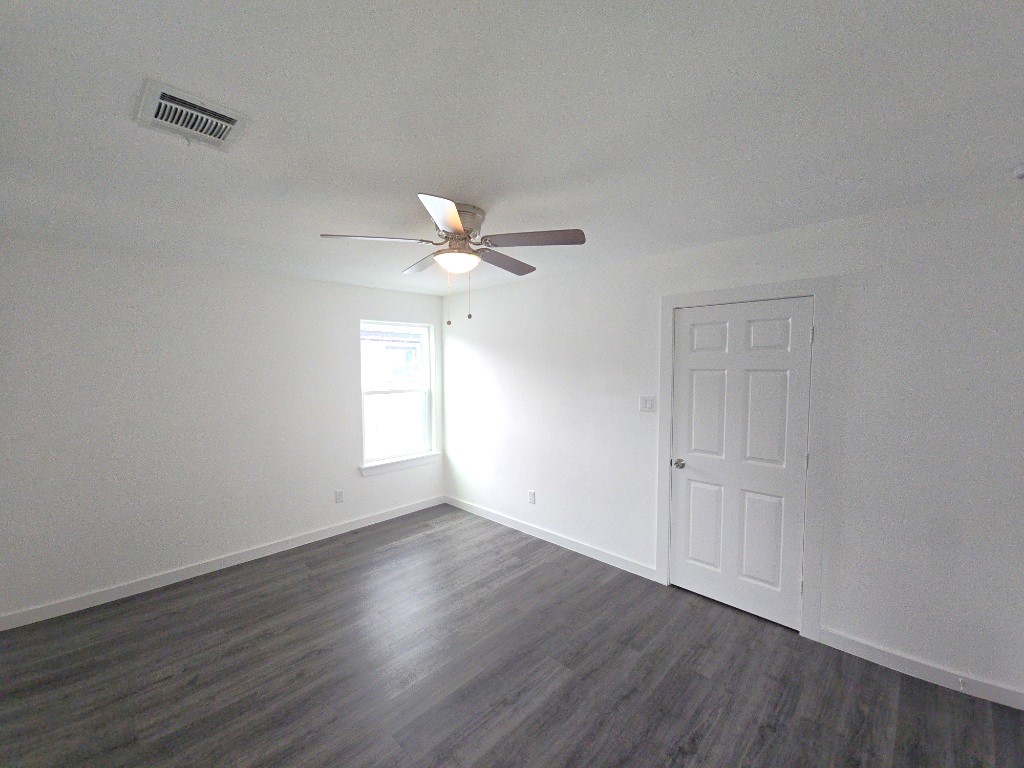 6315 Sandra Street, Unit A Houston, TX 77028 - Photo 10 of 21 a view of an empty room with wooden floor and a window