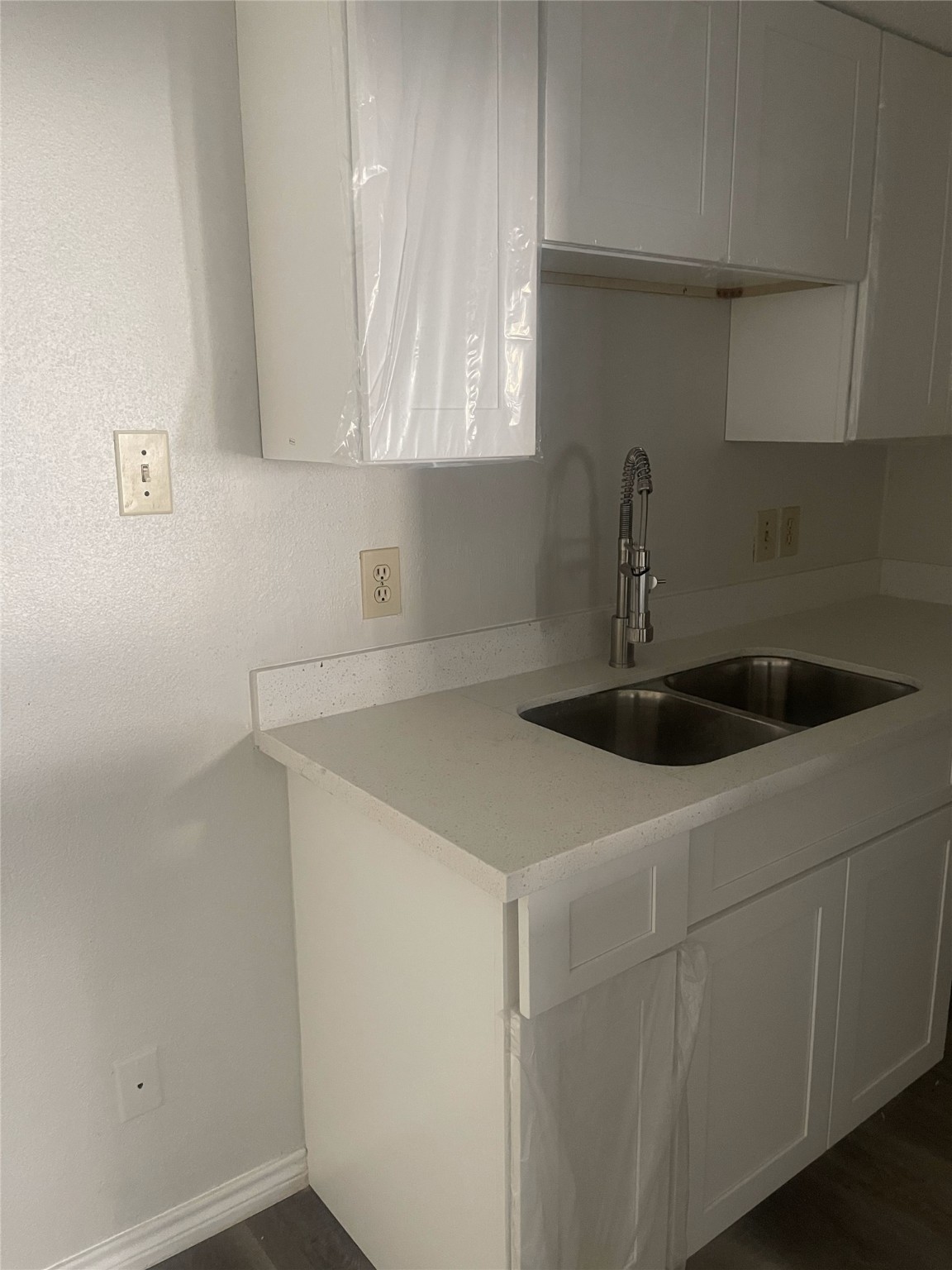 7402 Alabonson Road, Unit 309 Houston, TX 77088 - Photo 6 of 20 a kitchen with a sink and cabinets