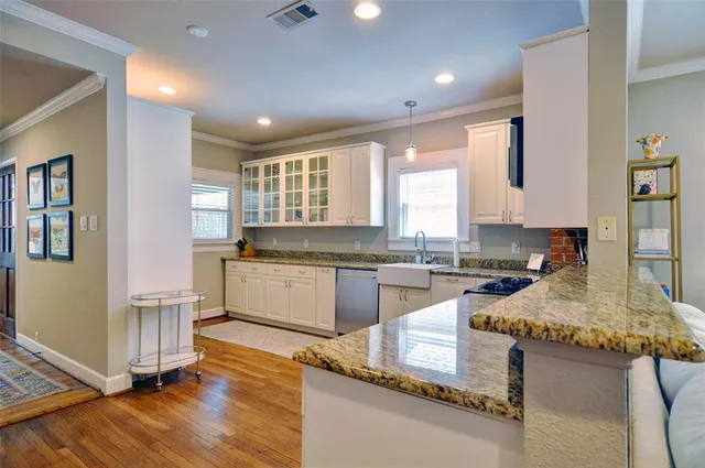 a kitchen with granite countertop white cabinets and white appliances