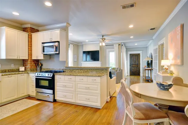 a room with painting on the wall and a window