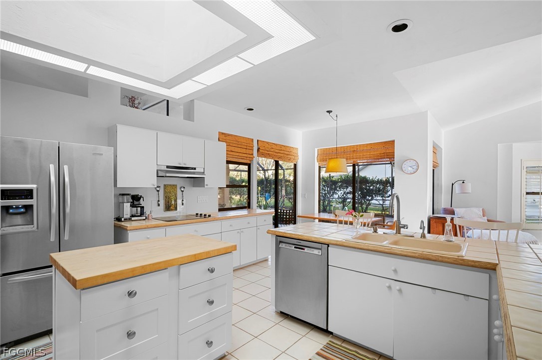 11772 Mahogany Run Fort Myers, FL 33913 - Photo 16 of 50 a kitchen with white cabinets and appliances