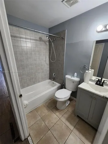 a bathroom with a toilet and a bathtub