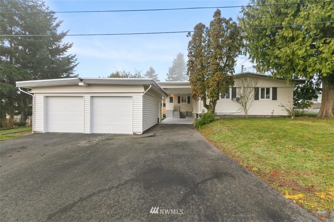 2613 Northeast 6th Place Renton, WA 98056 - Photo 1 of 27 a front view of a house with a yard and garage