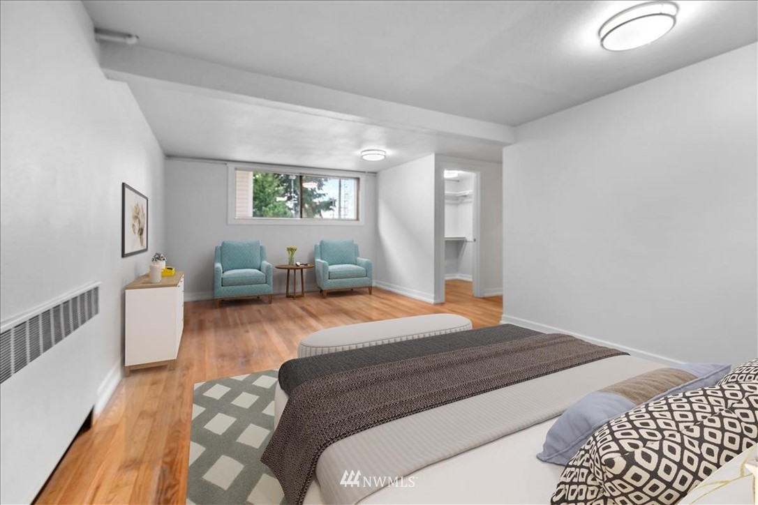 2613 Northeast 6th Place Renton, WA 98056 - Photo 19 of 27 a bedroom with a bed and wooden floor