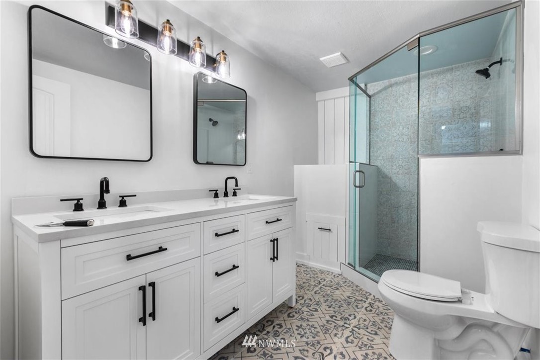 2613 Northeast 6th Place Renton, WA 98056 - Photo 21 of 27 a bathroom with a double vanity sink mirror and toilet
