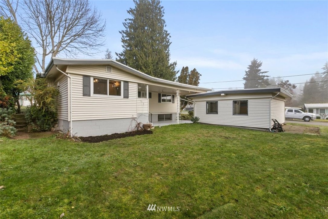2613 Northeast 6th Place Renton, WA 98056 - Photo 25 of 27 a front view of a house with a garden