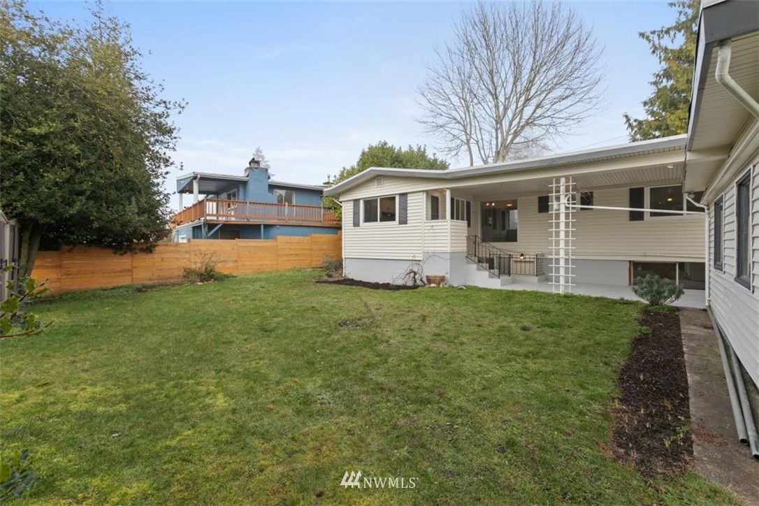2613 Northeast 6th Place Renton, WA 98056 - Photo 26 of 27 a front view of a house with a yard and trees