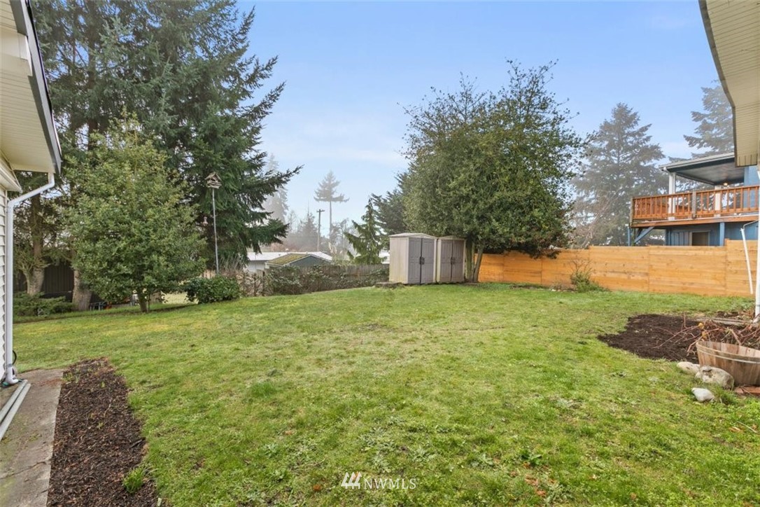 2613 Northeast 6th Place Renton, WA 98056 - Photo 27 of 27 a backyard of a house with lots of green space