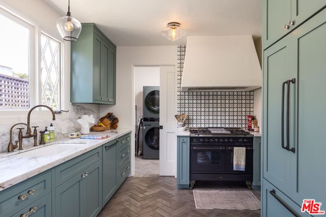 a kitchen with a sink stove and refrigerator