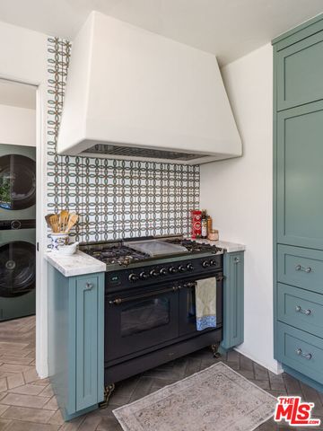 a stove top oven sitting inside of a kitchen
