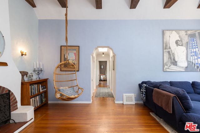 a living room with furniture and wooden floor