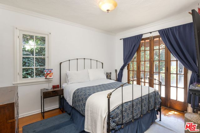 a bedroom with a bed and a large window