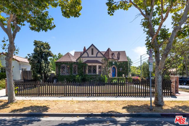 a front view of a house with a wrought fence
