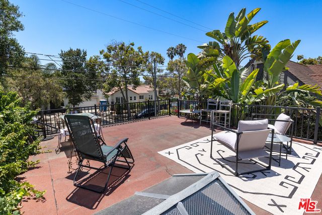 a view of a backyard with sitting area