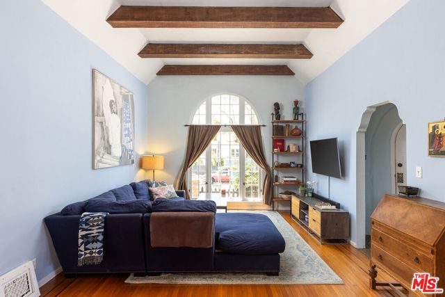 a living room with furniture a window and a flat screen tv