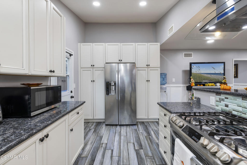 1231 Bluebell Street Oxnard, CA 93036 - Photo 12 of 44 a kitchen with stainless steel appliances granite countertop a stove a sink and a refrigerator
