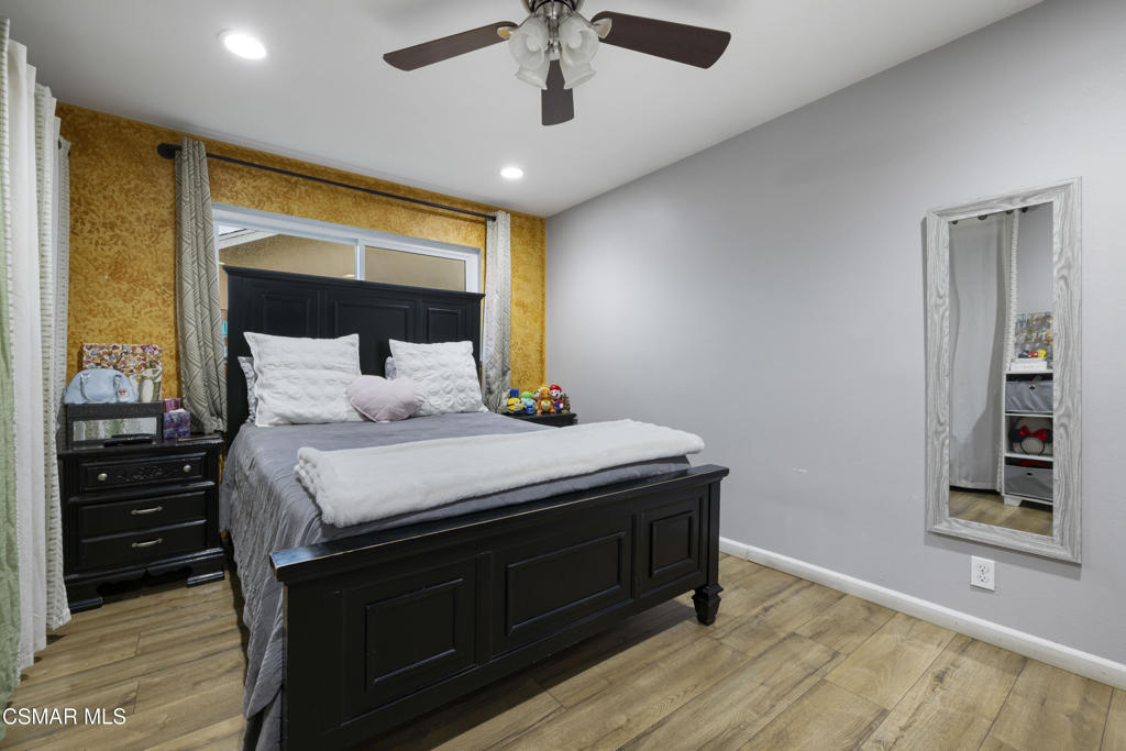 1231 Bluebell Street Oxnard, CA 93036 - Photo 19 of 44 a bedroom with a bed and wooden floor