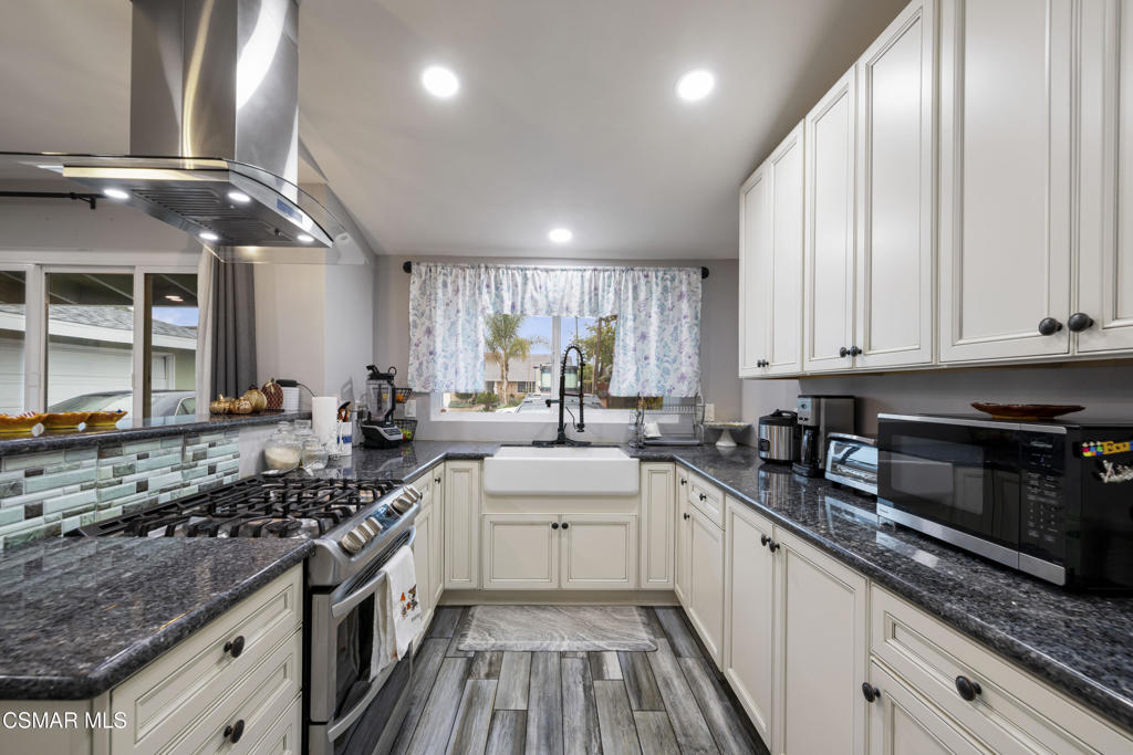 1231 Bluebell Street Oxnard, CA 93036 - Photo 9 of 44 a kitchen with stainless steel appliances granite countertop a sink stove and cabinets