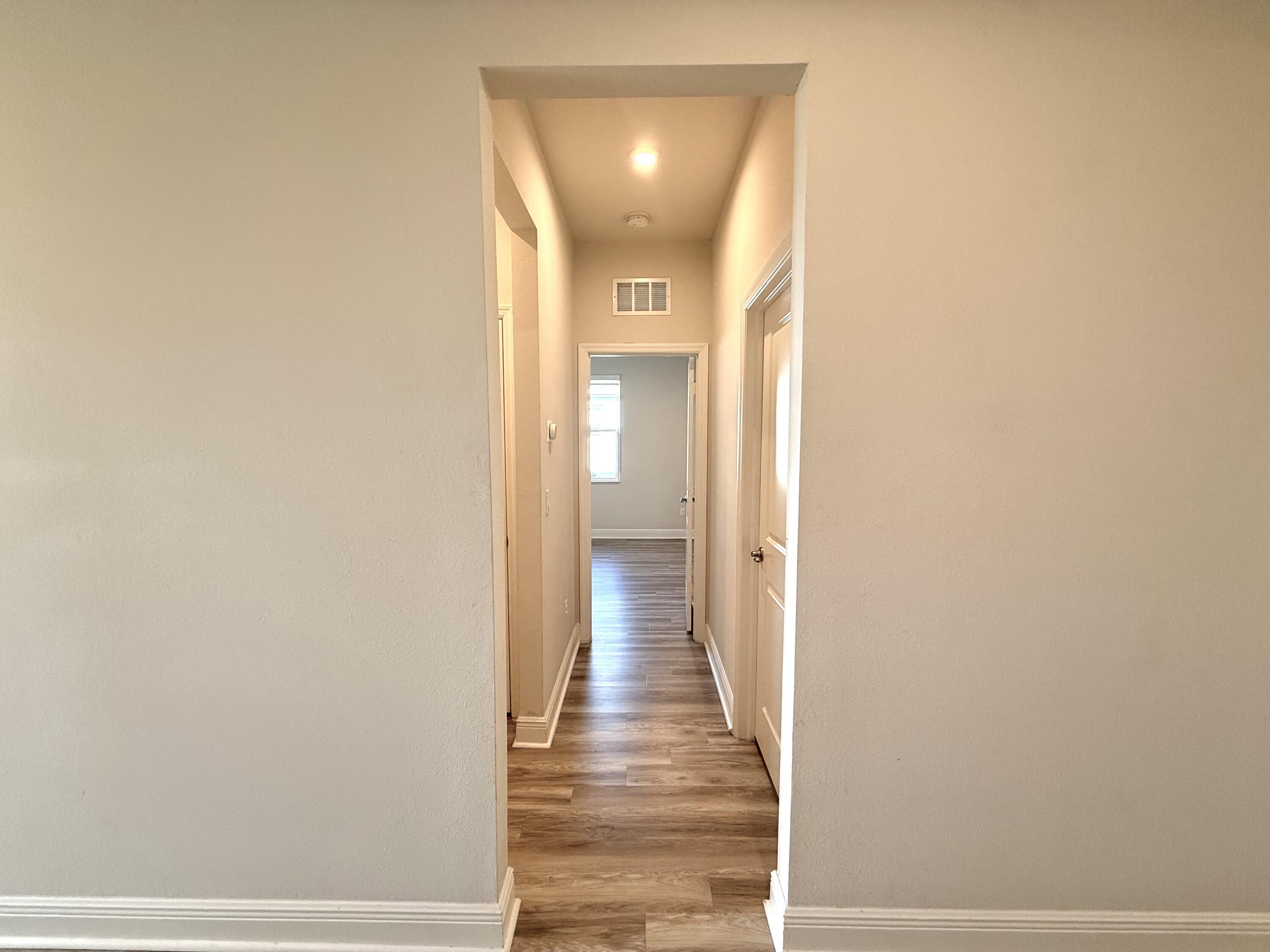 10819 Southwest Pacini Way Port St. Lucie, FL 34987 - Photo 15 of 43 a view of a hallway with wooden floor