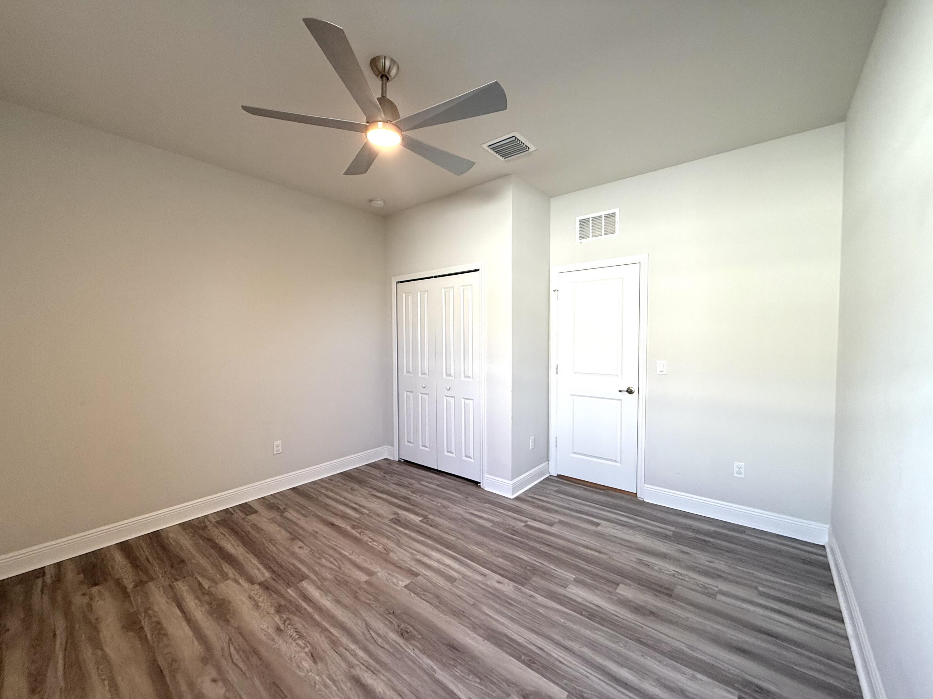 10819 Southwest Pacini Way Port St. Lucie, FL 34987 - Photo 17 of 43 wooden floor in an empty room