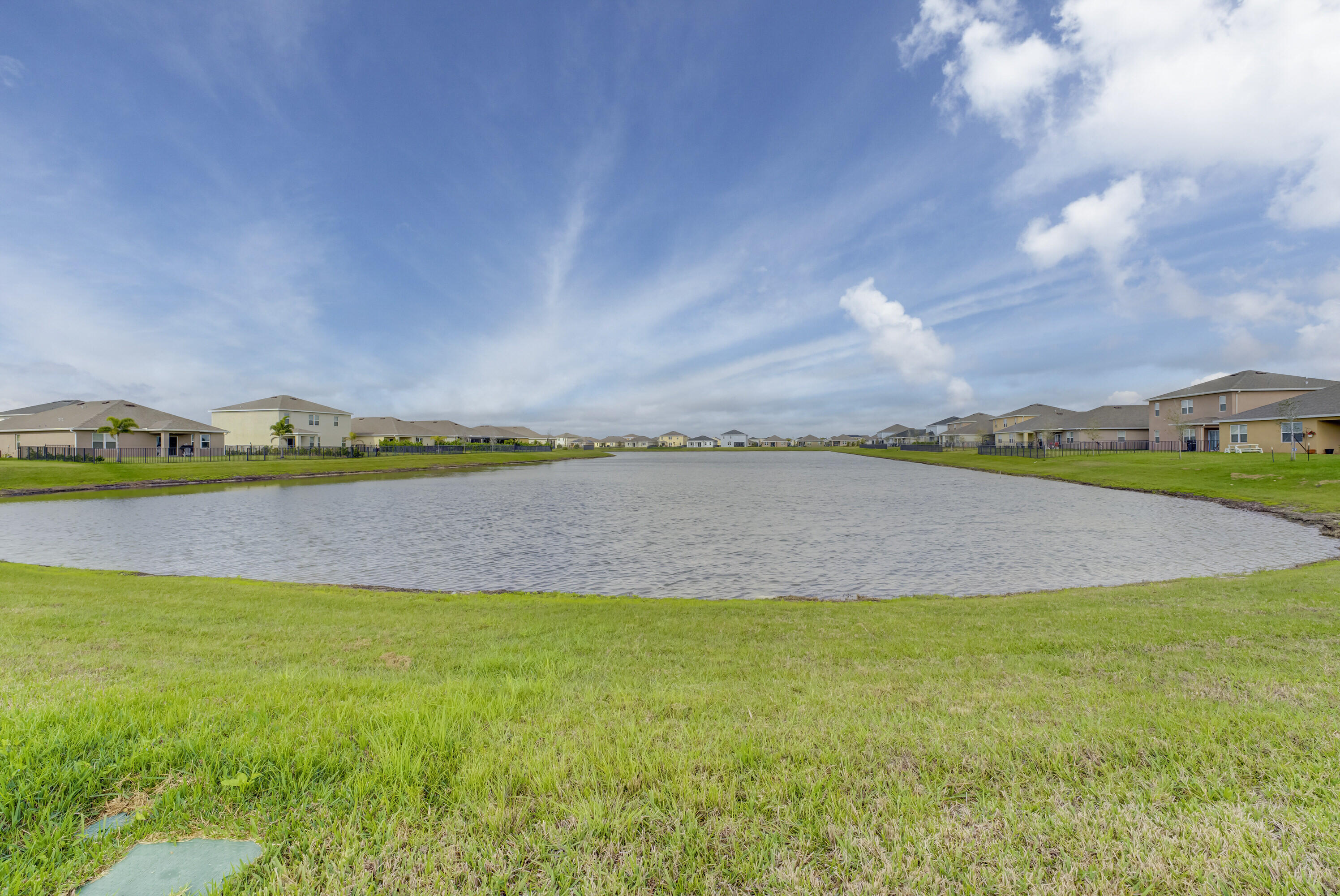 10819 Southwest Pacini Way Port St. Lucie, FL 34987 - Photo 33 of 43 a view of a lake with a big yard