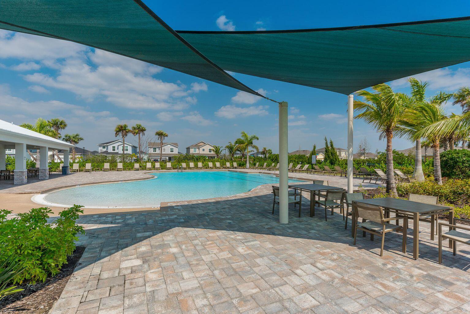 10819 Southwest Pacini Way Port St. Lucie, FL 34987 - Photo 5 of 43 a view of a swimming pool with a patio and a garden