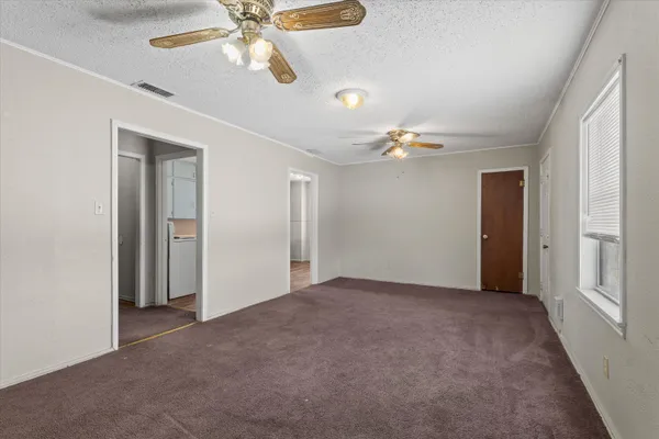 a view of a livingroom with a ceiling fan and window