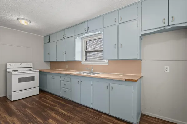 a kitchen with a sink cabinets and appliances