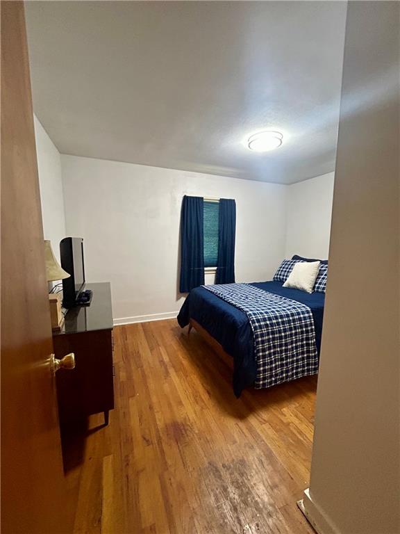 1133 Venetia Road Eighty Four, PA 15330 - Photo 16 of 26 a bedroom with a bed and wooden floor