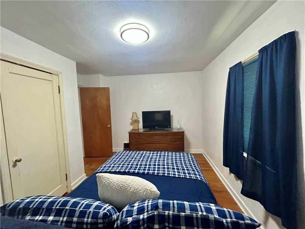 1133 Venetia Road Eighty Four, PA 15330 - Photo 17 of 26 a bedroom with a bed and wooden floor