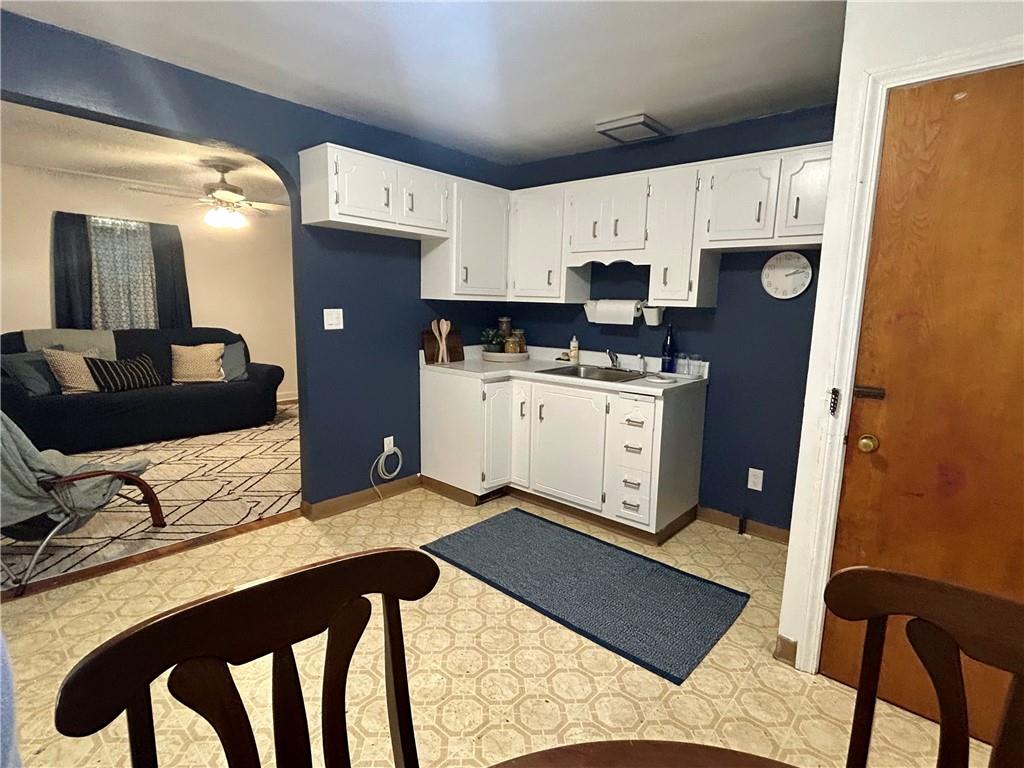 1133 Venetia Road Eighty Four, PA 15330 - Photo 7 of 26 a kitchen with stainless steel appliances a stove a refrigerator a sink a stove and white cabinets with wooden floor