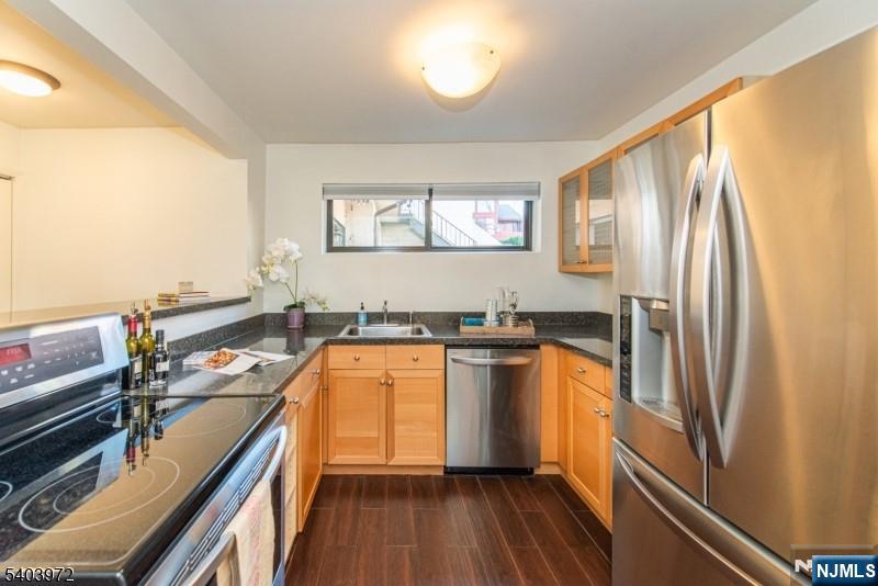 105 River Road, Unit C1 Nutley, NJ 07110 - Photo 11 of 22 a kitchen with stainless steel appliances granite countertop a refrigerator and a stove top oven