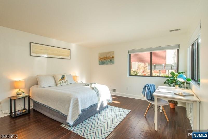 105 River Road, Unit C1 Nutley, NJ 07110 - Photo 13 of 22 a bedroom with a bed and a table