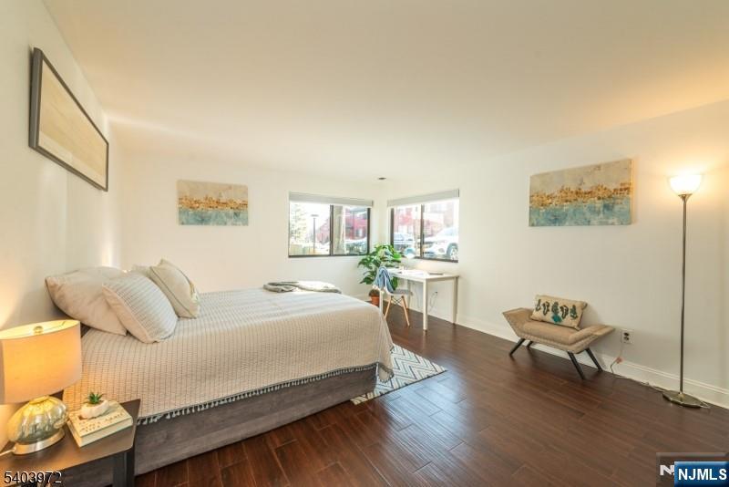 105 River Road, Unit C1 Nutley, NJ 07110 - Photo 14 of 22 a bedroom with a bed and a chair