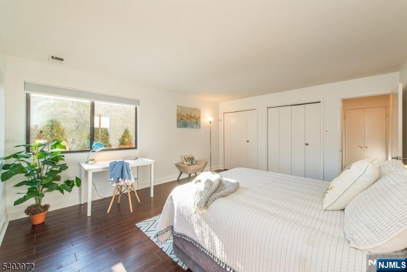 105 River Road, Unit C1 Nutley, NJ 07110 - Photo 15 of 22 a bedroom with a bed and a table