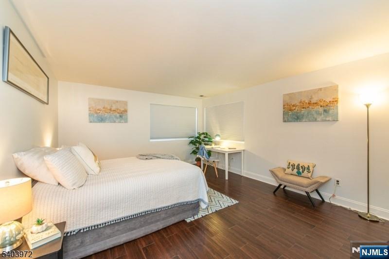105 River Road, Unit C1 Nutley, NJ 07110 - Photo 16 of 22 a bedroom with a bed and a table
