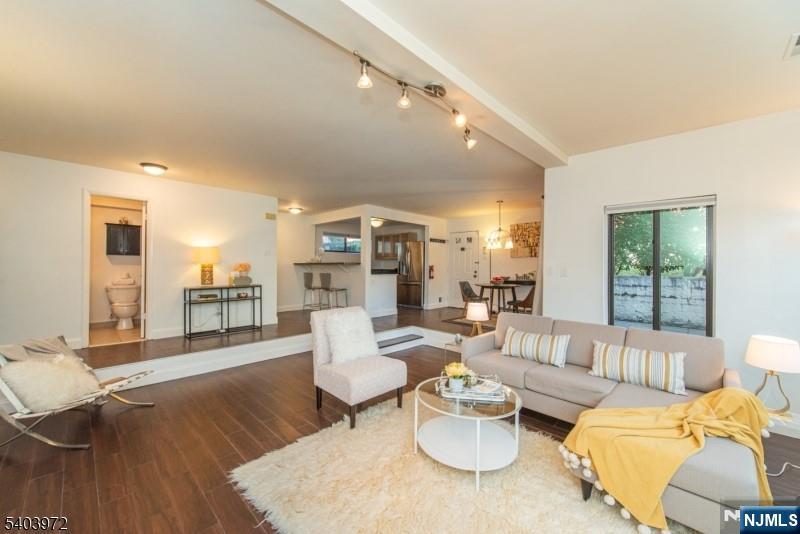 105 River Road, Unit C1 Nutley, NJ 07110 - Photo 2 of 22 a living room with furniture and a table