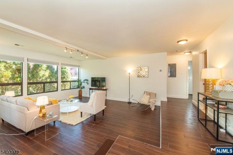 105 River Road, Unit C1 Nutley, NJ 07110 - Photo 3 of 22 a living room with furniture large window and a table