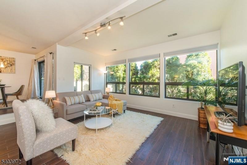 105 River Road, Unit C1 Nutley, NJ 07110 - Photo 4 of 22 a living room with furniture and a large window
