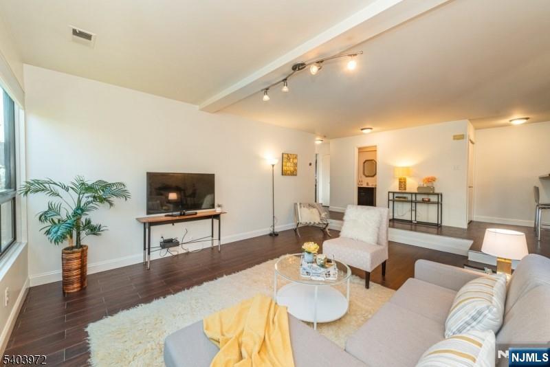 105 River Road, Unit C1 Nutley, NJ 07110 - Photo 5 of 22 a living room with furniture and a flat screen tv