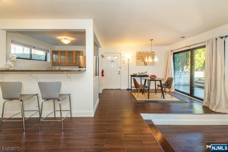 105 River Road, Unit C1 Nutley, NJ 07110 - Photo 6 of 22 a view of a dining room with furniture and wooden floor