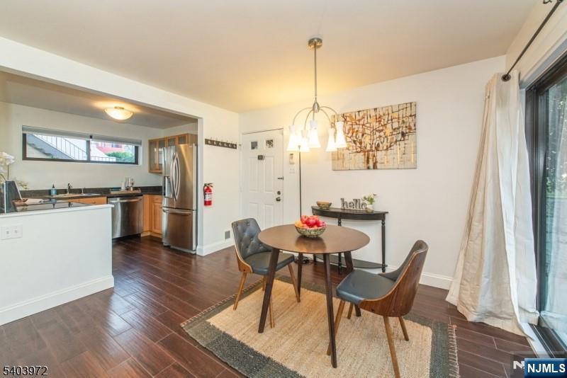 105 River Road, Unit C1 Nutley, NJ 07110 - Photo 8 of 22 a view of a dining room with furniture and wooden floor