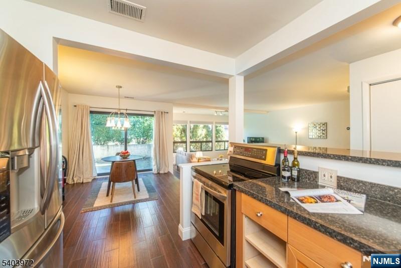 105 River Road, Unit C1 Nutley, NJ 07110 - Photo 9 of 22 a kitchen view with a stove and wooden floor